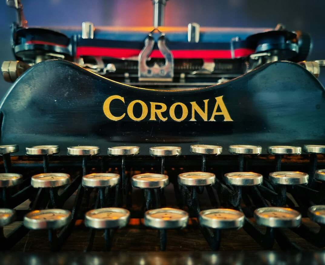 Vintage typewriter with papers on a wooden desk