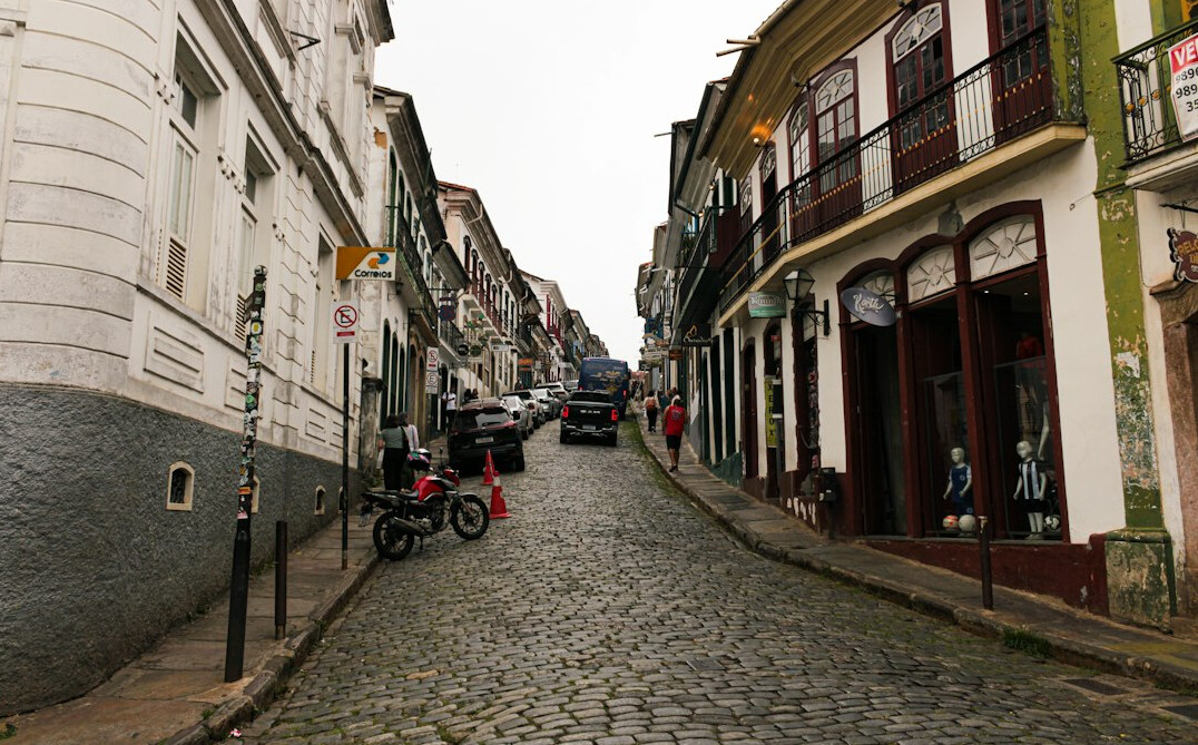 Foggy cobblestone street with colonial buildings